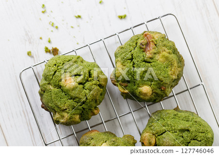 Closeup of fresh baked matcha cookies on white wooden background. Closeup of fresh baked matcha cookies on white wooden background. 127746046