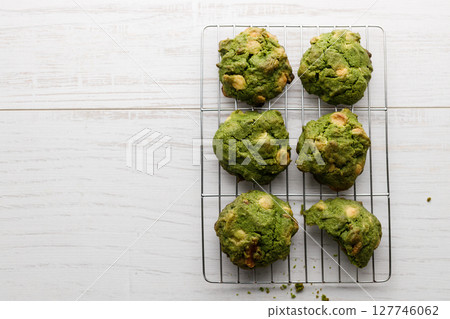 Closeup of fresh baked matcha cookies on white wooden background. Closeup of fresh baked matcha cookies on white wooden background. 127746062