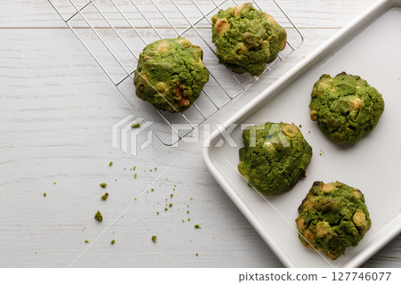Closeup of fresh baked matcha cookies on white wooden background. 127746077