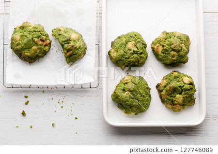 Closeup of fresh baked matcha cookies on white wooden background. 127746089