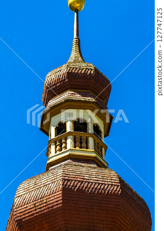 Barbara church cathedral with dome tower blue sky Tyrol Austria. Barbara church cathedral with dome tower blue sky Tyrol Austria. 127747125