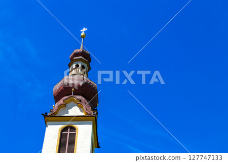 Barbara church cathedral with dome tower blue sky Tyrol Austria. Barbara church cathedral with dome tower blue sky Tyrol Austria. 127747133