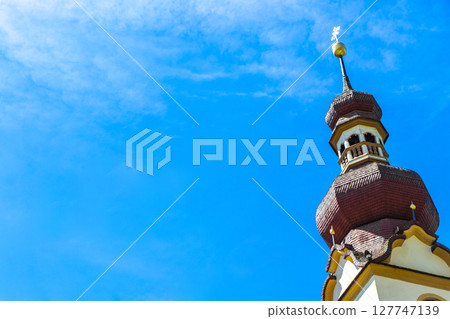 Barbara church cathedral with dome tower blue sky Tyrol Austria. Barbara church cathedral with dome tower blue sky Tyrol Austria. 127747139