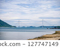 Spectacular view of the Seto Inland Sea overlooking Tatara Bridge and Ikuchijima Island | Blue sky, white clouds, and sandy coastline 127747149