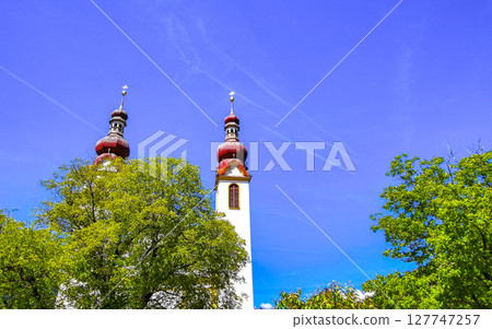 Barbara church cathedral Barbarakirche Fliess with blue sky Tyrol Austria. Barbara church cathedral Barbarakirche Fliess with blue sky Tyrol Austria. 127747257