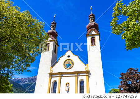 Barbara church cathedral Barbarakirche Fliess with blue sky Tyrol Austria. 127747259