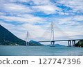 Spectacular view of the Seto Inland Sea overlooking Tatara Bridge and Ikuchijima Island | Blue sky, white clouds, and sandy coastline 127747396