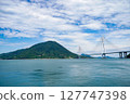 Spectacular view of the Seto Inland Sea overlooking Tatara Bridge and Ikuchijima Island | Blue sky, white clouds, and sandy coastline 127747398