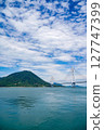 Spectacular view of the Seto Inland Sea overlooking Tatara Bridge and Ikuchijima Island | Blue sky, white clouds, and sandy coastline 127747399