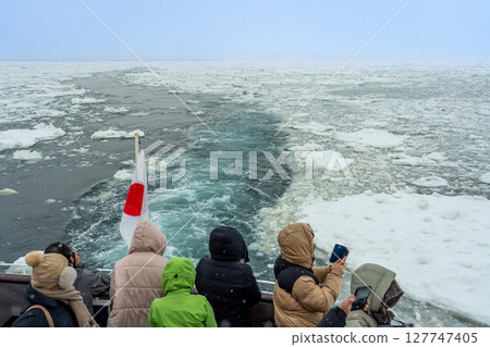 Abashiri City, Hokkaido - Tourists taking photos of the drift ice surface from the Aurora drift ice sightseeing icebreaker Abashiri City, Hokkaido - Tourists taking photos of the drift ice surface from the Aurora drift ice sightseeing icebreaker 127747405