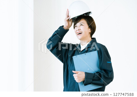 Senior woman in work clothes Senior woman in work clothes 127747588