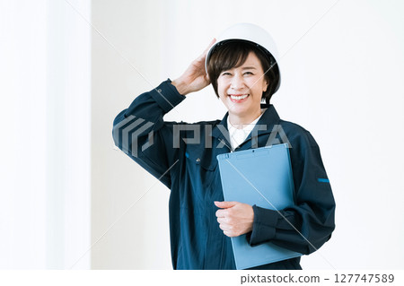 Senior woman in work clothes Senior woman in work clothes 127747589