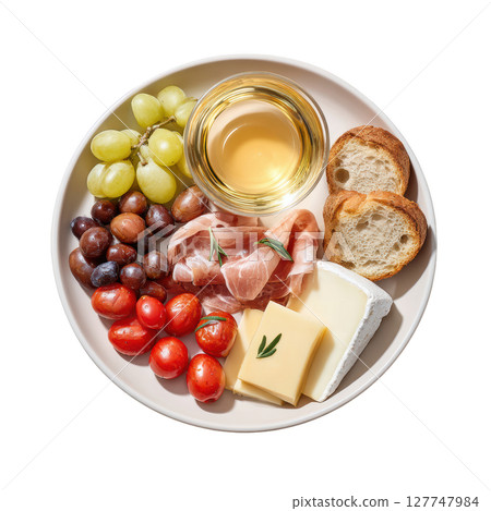 Delicious Mediterranean Platter with Cheese, Olives, Grapes, Tomatoes, Prosciutto and a Glass of White Wine 127747984
