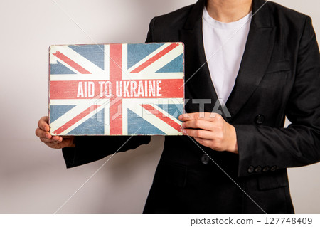 British Support for Ukraine. Flag Sign Held by Person in Business Attire British Support for Ukraine. Flag Sign Held by Person in Business Attire 127748409