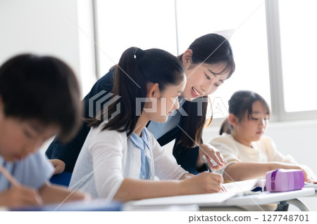 Children concentrating on studying at a cram school 127748701