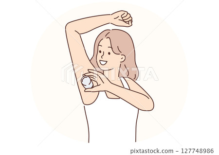 Woman raising hand using deodorant during morning hygiene routine to avoid sweat and odor 127748986