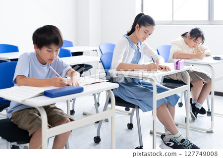 Children studying at school 127749008
