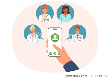 Doctors around phone in patient hand, for concept calling medical personnel at home, for first aid 127749137