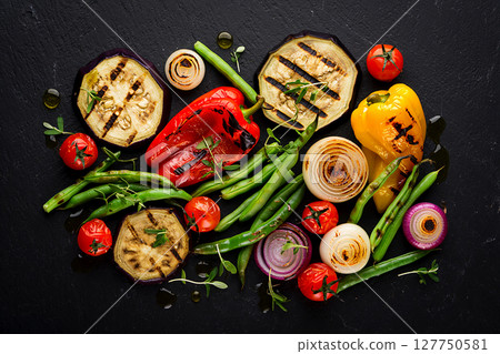 grilled vegetables - eggplant, pepper, onion, tomato and beans on black background. 127750581