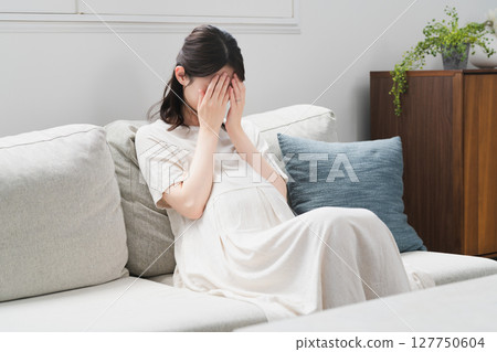 Pregnant woman relaxing on the sofa lifestyle image Pregnant woman relaxing on the sofa lifestyle image 127750604