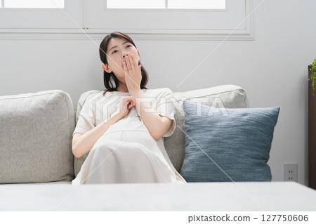 Pregnant woman relaxing on the sofa lifestyle image Pregnant woman relaxing on the sofa lifestyle image 127750606
