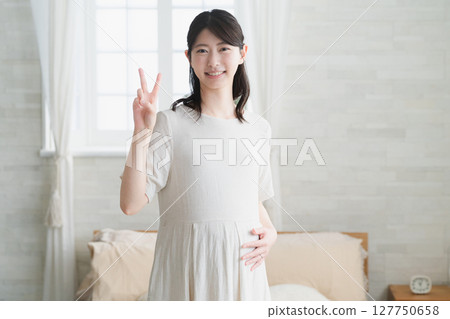 Pregnant woman rubbing her belly lifestyle image Pregnant woman rubbing her belly lifestyle image 127750658