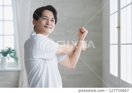 Young man wearing a T-shirt Lifestyle image Young man wearing a T-shirt Lifestyle image 127750667