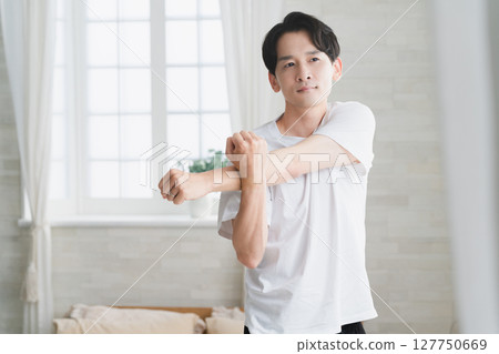 Young man wearing a T-shirt Lifestyle image Young man wearing a T-shirt Lifestyle image 127750669