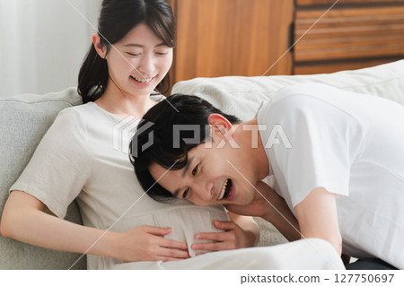 丈夫把耳朵貼在孕婦的肚子上生活風格圖像 丈夫把耳朵貼在孕婦的肚子上生活風格圖像 127750697