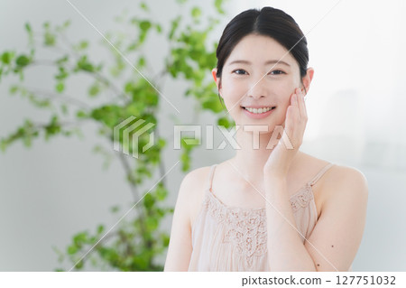 Beauty image of a young woman doing skin care Beauty image of a young woman doing skin care 127751032