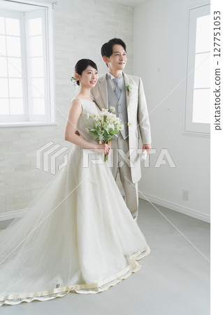 Bride in a dress and groom in a tuxedo Wedding image 127751053