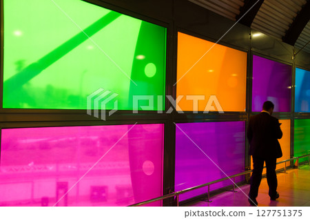 Man walking by stained glass windows. Man walking by stained glass windows. 127751375
