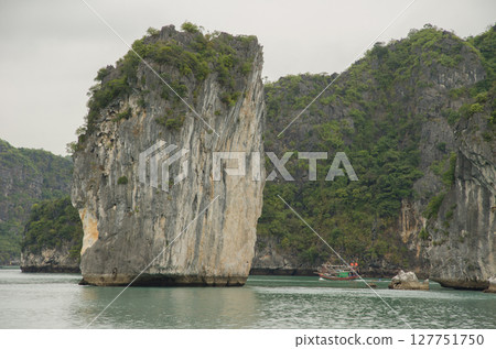 Limestone cliff and fishing boat. Limestone cliff and fishing boat. 127751750