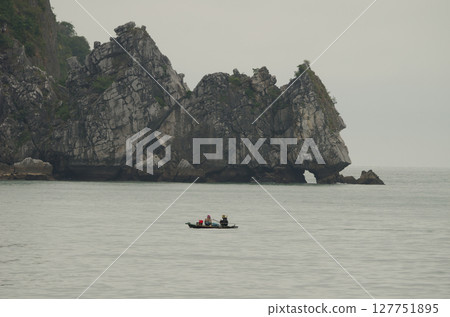 Fishing boat and limestone cliff. 127751895