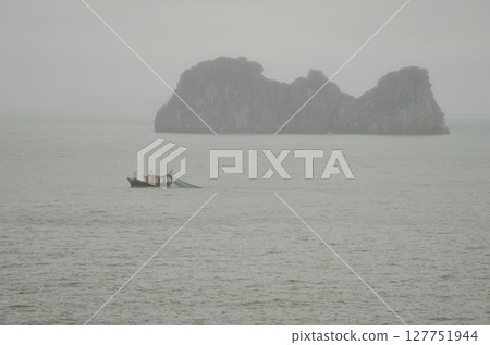Fishing boat and limestone cliff. Fishing boat and limestone cliff. 127751944