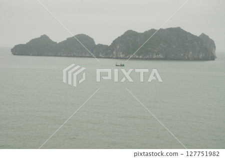 Fishing boat and limestone cliff. 127751982