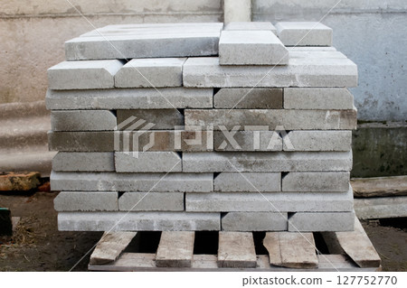 A pallet loaded with paver and stone material for outside construction. Represents key supply for landscaping and building projects 127752770