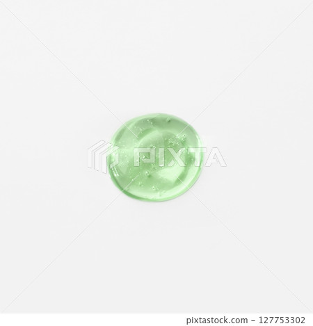 Green cosmetic gel drop on a white background Green cosmetic gel drop on a white background 127753302