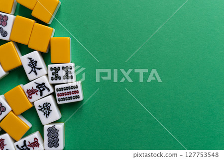 Mahjong tiles on a green background Mahjong tiles on a green background 127753548