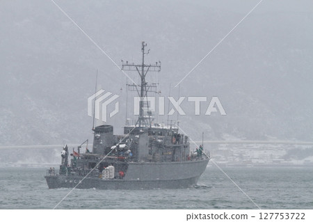 A minesweeper sailing through winter seas A minesweeper sailing through winter seas 127753722