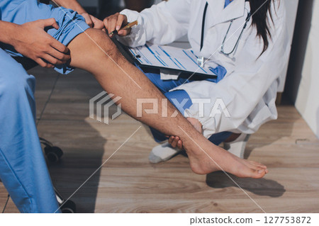 Physical therapist teaching a patient how to do exercises for his knee pain Physical therapist teaching a patient how to do exercises for his knee pain 127753872