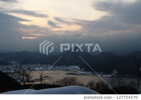 Winter landscape with snow-covered mountains and the sea Winter landscape with snow-covered mountains and the sea 127754570