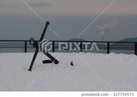 Anchor stuck in the snow 127754573