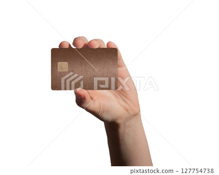 holding a brown bank card for payment, emphasizing security and financial services in a retail store holding a brown bank card for payment, emphasizing security and financial services in a retail store 127754738