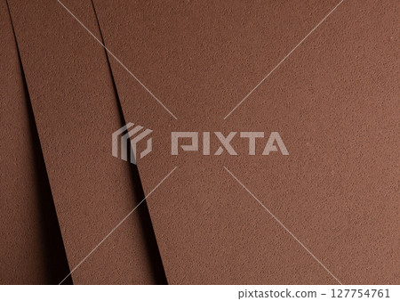 Minimalistic closeup of brown designer paper with chocolate and coffee tones. Geometric perforated Minimalistic closeup of brown designer paper with chocolate and coffee tones. Geometric perforated 127754761