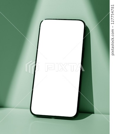 Phone screen mockup. Modern black smartphone with glowing touch screen, pastel green background, 127754781