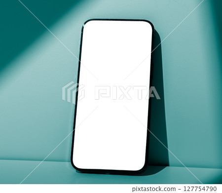 Smartphone mockup closeup. Black mobile device with screen leaning against blue mint colored pastel Smartphone mockup closeup. Black mobile device with screen leaning against blue mint colored pastel 127754790