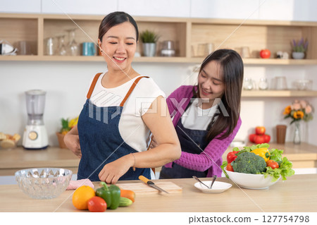Joyful Cooking Experience: Women Enjoying Food Prep in Bright Kitchen Joyful Cooking Experience: Women Enjoying Food Prep in Bright Kitchen 127754798