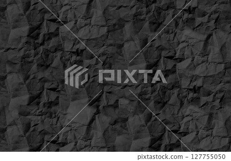Crumpled black paper texture with rough, wrinkled surface and natural creases. Vintage, aged effect Crumpled black paper texture with rough, wrinkled surface and natural creases. Vintage, aged effect 127755050