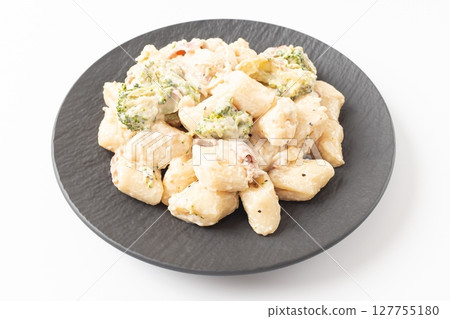 Cream Tteokbokki Korean Rice Cake with Bacon and Broccoli on White Background 127755180